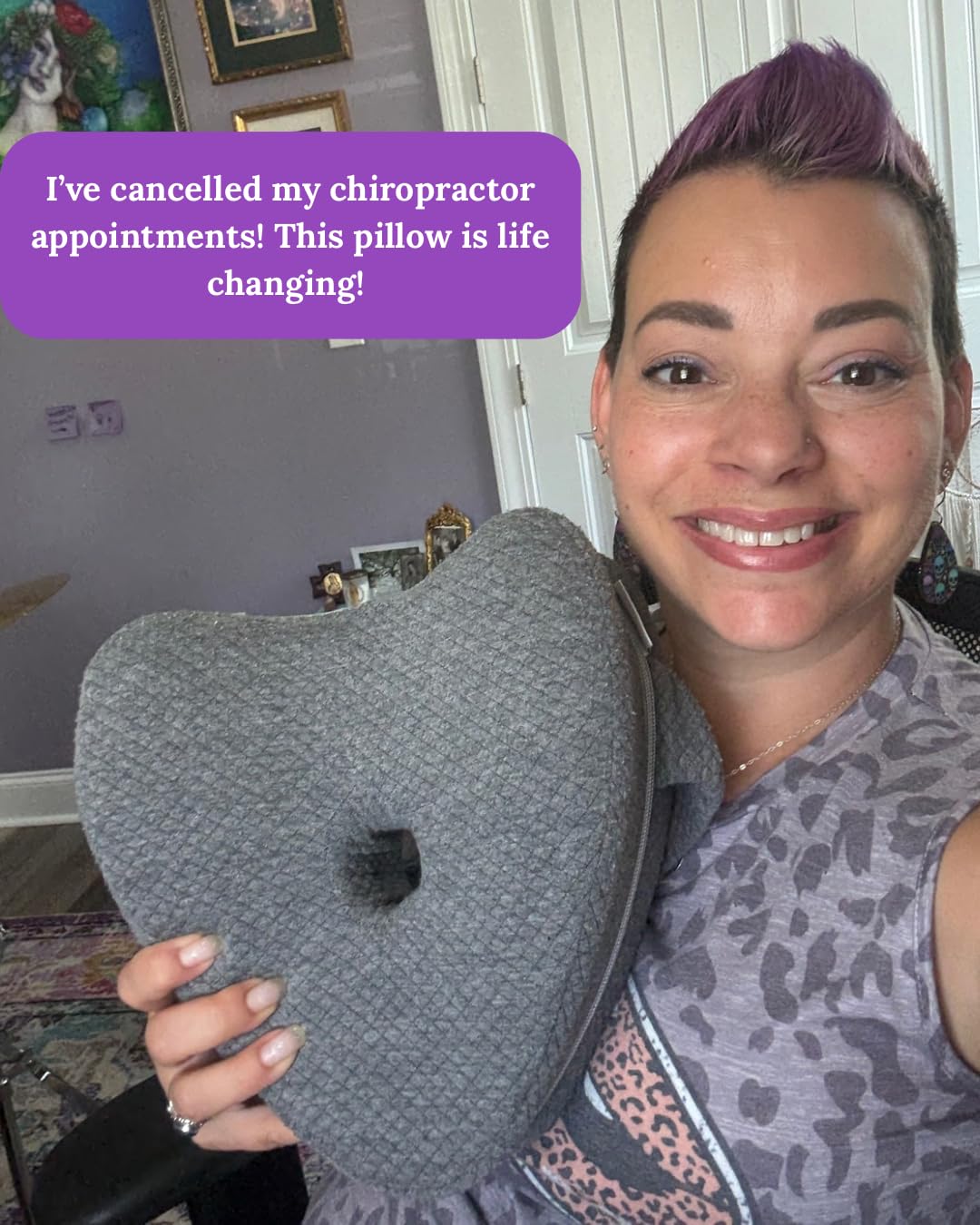 Smiling woman holding a gray side sleeper alignment pillow