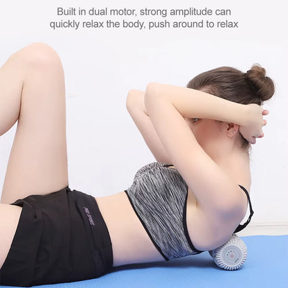 Woman lying on a blue mat with a white vibrating roller beneath her upper back