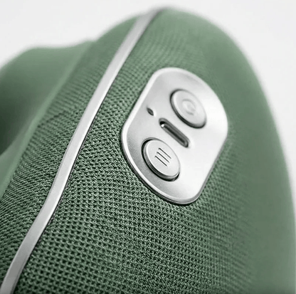 Close-up of the control buttons and charging port on the green hands-free massager
